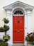 Red door in architecturally decorative entrance