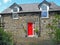 Red door on Front of Converted Barn Guest house in Ireland 2