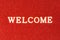 Red doormat and welcome text