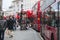 Red double-decker bus pass under twinkling Christmas angels lighting up the upscale shopping district