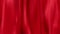 Red draped curtain as background, seamless loop ready animation