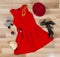 Red dress and accessories arranged on the floor.