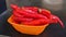 Red dried chili in a bowl with white background. A bowl of moist red chilli peppers