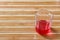 Red drink on bamboo floor
