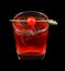 Red drink with a maraschino cherry isolated on black