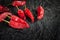 Red dry pepper. A group of hot dried chili peppers on a black charcoal surface