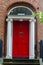 Red Dublin door over brick wall