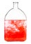 Red dye dissolves in water in bottle isolated