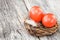 Red Easter eggs in little nest on old wooden table. Selective focus