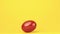Red egg revolving against yellow background