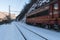 Red electric locomotive in the winter moving in snow covered land