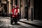 A red electric scooter is parked in the city at roundabout