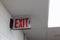 red emergency exit sign in the dark room. illuminated office exit sign