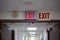 red emergency exit sign in the dark room. illuminated office exit sign