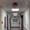 red emergency exit sign in the dark room. illuminated office exit sign