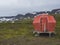 Red emergency shelter cabin in hloduvik campsite standing on the
