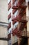 Red emergency staircase in a building facade