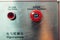 Red emergency stop button, inscriptions in English and Chinese
