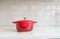 Red enameled cast iron covered round dutch oven