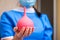 Red enema in the palm of a nurse is closeup. Selective focus. Medical concept