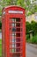 A red English phone box in a rural Cotswold village