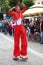 Red entertainer on stilts and big boots