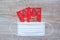 Red envelope or Ang pao and Medical face mask against Coronavirus disease infection. Chinese character means happiness or good