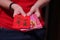Red Envelope with blessing words for Chinese New Year Gifts held in hand