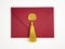 Red envelope with golden wax stamp and silk tassel for gift certificate or invitation. Top view
