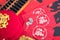 Red envelopes and traditional abacus and red lanterns and coins on red spring couplets background. The Chinese character on the re