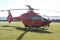 Red Eurocopter EC135 helicopter on grass