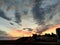 Red evening sky and trailing clouds with silhouette buildings