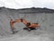 Red excavator in the quarry for loading aggregates