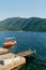 Red excursion boat moored at the pier against the backdrop of mountains