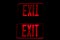 Red Exit Sign Reflection on Black