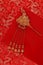 Red fabric with dragon pattern with red copy space for text and golden female hairpin. Concept of Chinese New year and wedding