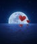 Red fabric heart air balloon on fantasy sea sky and moon,