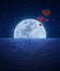 Red fabric heart air balloon on fantasy sky and moon