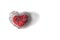 Red fabric heart in knitted wire cage