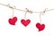 Red fabric hearts hanging on the clothesline