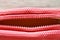 Red fabric purse zipper slide opened on wooden board