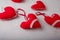 Red fabric sewn hearts soft toys on white background. Valentines day small souvenirs, Christmas tree toys with lace, buttons