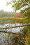 Red fall foliage in fog at Morey Pond, New Hampshire