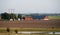 Red farm buildings and barns in the middle of the flat farmlands of SkÃ¥ne Scania during summer in Sweden