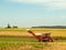 Red Farm cane harvester on agriculture land