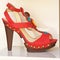 Red fashion shoe with decoration.