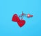Red felt hearts hanging on an iron lock, blue background