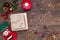 Red felt stocking with the image of Santa Claus, fir branches, cones and Christmas tree decorations, a candle, gold beads on a