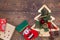 Red felt stocking and metallic golden fir tree with branches and cones, Christmas decorations, beads and gifts wrapped in paper on