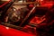 Red Ferrari sports car in a vibrant red hue is parked in a showroom in Italy.